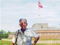 Veteran Dang Van Viet in front of the Ky Dai (Flag Tower) in Ngo Mon gate of Hue City.